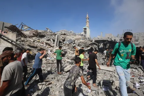 Palestinians inspect the site of an Israeli strike on the Bureij camp for Palestinian refugees in the central Gaza Strip on June 15, 2025.Credit: AFP/EYAD BABA