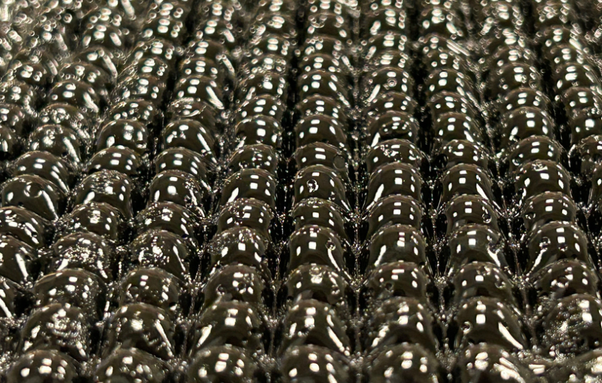 A close-up of a new origami-inspired hydrogel material, designed by MIT engineers, that swells to absorb water from the air. When water condenses out of the material to be collected, the individual hydrogel spheres shrink back down to capture more moisture.
