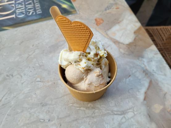 Cut of ice cream, with a waffle and a spoon