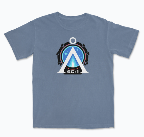 A four color Stargate-inspired design showing the Earth Chevron at the center of the Stargate with the initials SG-1 below it on a blue shirt