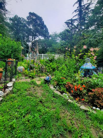Colorful, lush garden with a beaded ball tree.