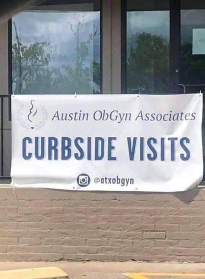 a sign on a building that says 

Austin ObGyn Associations
Curbside Visits