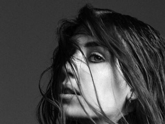 black and white photo of Lykke Li looking at the camera with her hair obscuring her face