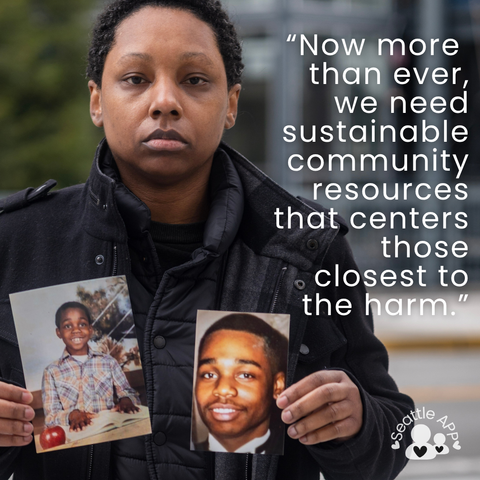 Image description: Image is of a woman looking directly into the camera holding two photos. In the corner of the image is the Seattle APP logo. 

In the corner is white text that states “Now more than ever, we need sustainable community resources that centers those closest to the harm.”
