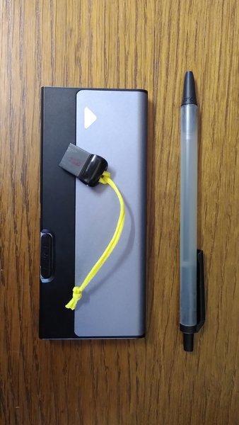 Photo of a USB thumbdrive and nvme-to-usb data drive, smaller than the pen next to it (as size reference). Awesome!