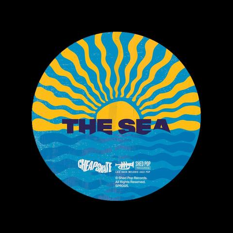 This is the cover art for Cheapskate's" The Sea" single on Shed Pop records . It shows a seven inch record center of a circular illustration with a yellow sun and blue waves. Text reads "THE SEA" in bold and includes logos and copyright details. Retro vibe.