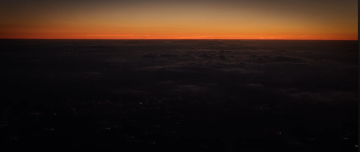 a desert with a rising sun