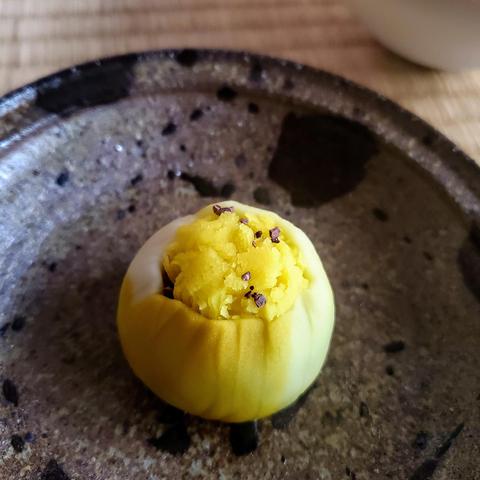 Vivid yellow sweet mimicking the head of a butterbur flower.