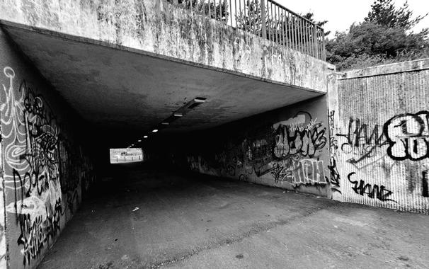 An image of a bypass covered in grafitti art.