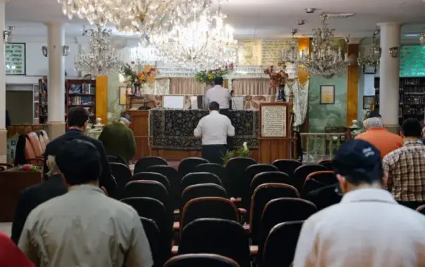 Iranian Jews pray in a synagogue in Tehran, Iran, in 2016 [File: Abedin Taherkenareh/EPA]

In Isfahan, one of the cities most prominent synagogues is located next to a mosque called Al Aqsa, and in the capital Tehran there are at least 50 synagogues spread across the city.
The Jewish community also runs a hospital in Tehran that caters to all patients regardless of their religious affiliation. It is located in Oudlajian, one of the oldest and most affluent districts of the capital near the country’s renowned Grand Bazaar.
Jewish ties to Iran go back as far as 2,700 years ago, Younes Hamami Lalehzar, a senior rabbi at Abrishami Synagogue in Tehran, once told me in an interview.
It is believed that the Jewish heroine, Esther, and her uncle, Mordechai, are buried in the western Iranian city of Hamedan. According to Jewish biblical text, Esther was married to the Persian king, Xerxes.
In more recent history, Iran gave safe haven to Jews who fled the Spanish Inquisition. During German Nazi leader Adolf Hitler’s rampage of Europe, Polish Jews sought refuge in Iran.
But there have also been periods of unrest, such as the forced conversion of Jews to Islam during the Safavid and Qajar era, and the migration of thousands of Iranian Jews to the US and Israel following the 1979 Islamic revolution.