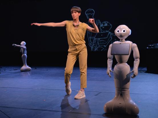 Female dancer with a robot on a stage