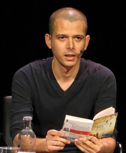 Colour photograph of author Abdellah Taïa at a reading.