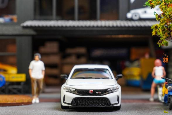 A front side of Honda Civic Type R (FL5), Spoon Sports Livery on White by Motor Helix in 1:64 scale with 1:64 figure on AREA 164