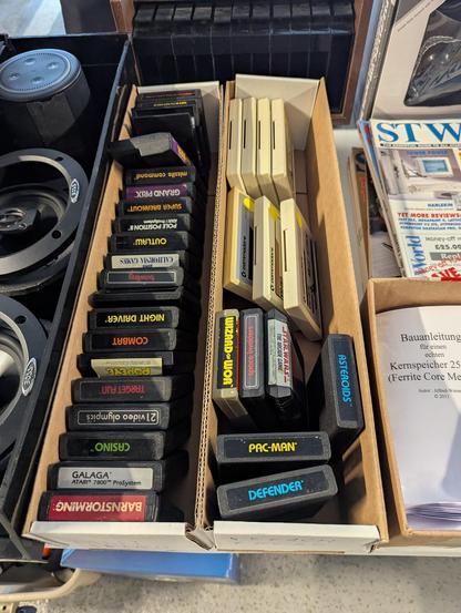 A box of a few dozen Atari and Commodore cartridges, for sale at the MIT Flea in Cambridge, Massachusetts, USA on 2025.06.15.