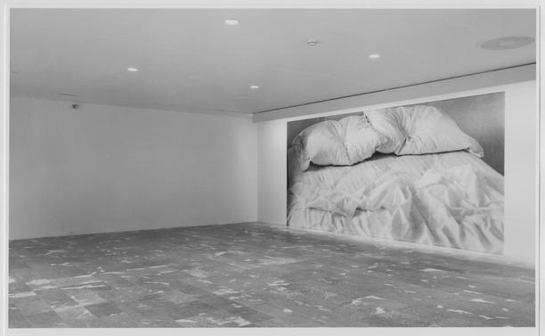 Large scale photo of artist's bed in museum and on billboards.