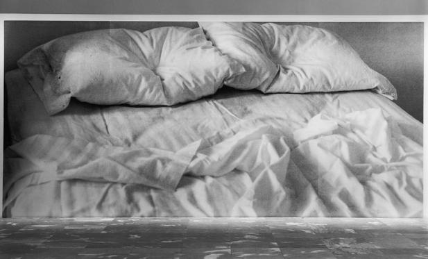 Large scale photo of artist's bed in museum and on billboards.