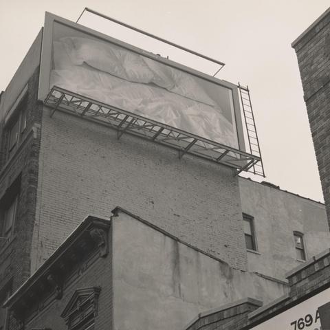 Large scale photo of artist's bed in museum and on billboards.