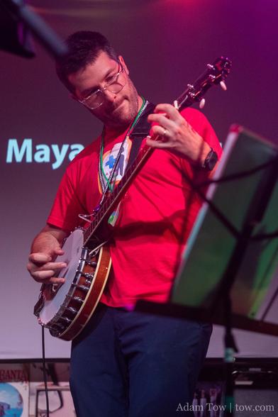 Adrian Eves fingerpicking on banjo. Photo by Adam Tow.