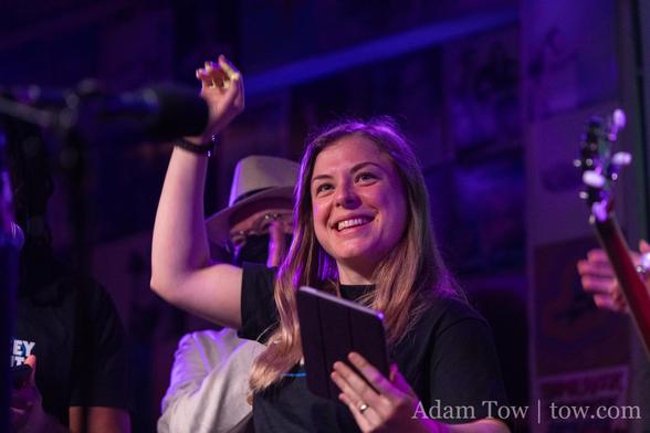 Danijela Vrzan smiling with her right arm raised and an iPad mini in her left hand. Photo by Adam Tow.