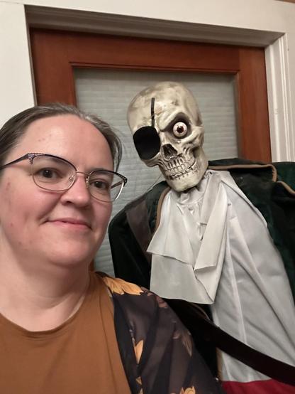 Liz Marley standing next to the pirate skeleton that guards the front door of the Art Boutiki. Photo by Liz Marley.