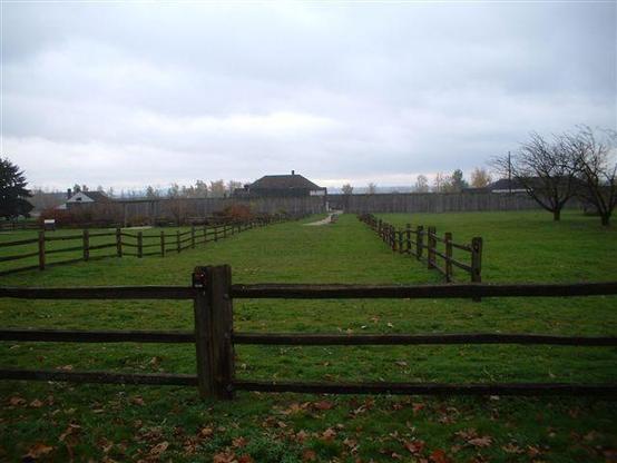 Fort Vancouver on a dark, overcast morning, with the Big House peeping over the palisades. 