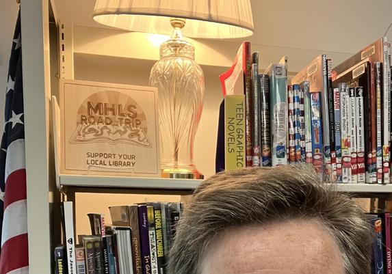 a poor selfie in front of the “road trip” logo, and a vintage lamp on a shelf full of books. 