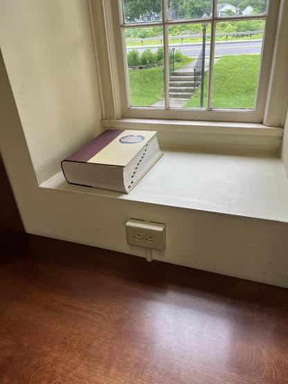 there’s a table in front of the window, and a thick, old-fashioned dictionary on the windowsill. 😊