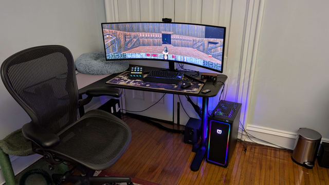 A fancy gaming PC setup with a high end gaming PC, large ultrawide monitor, prosumer keyboard and mouse, playing Master Levels for Doom 2