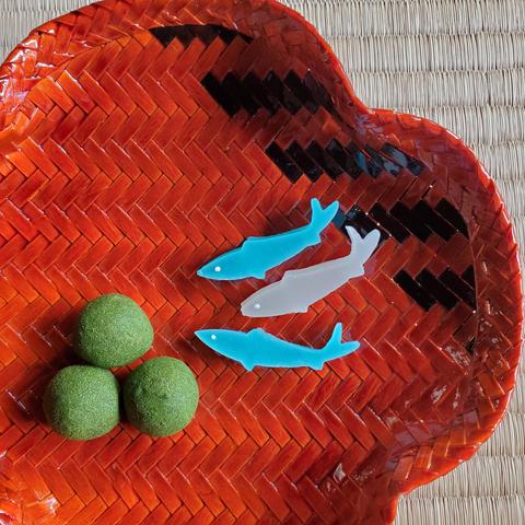 Jellied sweets in the shape of fish nibble on moss-like balls of soy flour and sugar.