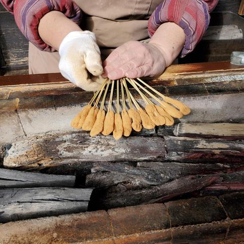 Aburi-mochi...bite size rice cakes on bamboo skewers cooked over charcoal.
