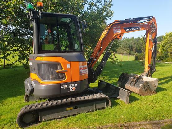 A small orange digger, unceremoniously dumped on the lawn.