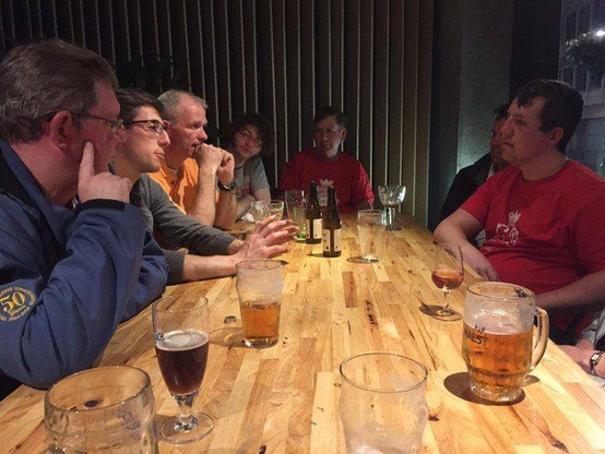 Late night in a cafe discussing the day's events over beer