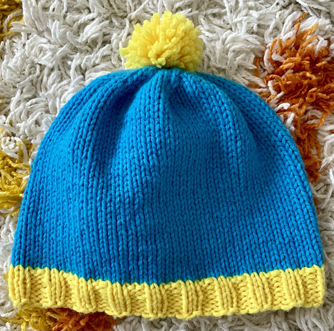 A blue and yellow hand-knit beanie 