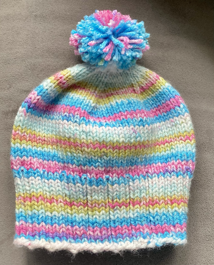 A pastel multicolor hand-knit beanie 