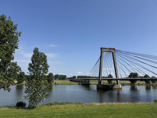 Lower half the river Maas, a bridge from the right side over the river 