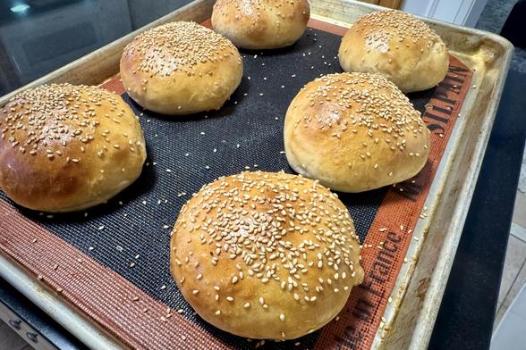 Sesame seed topped hamburger buns freshly out of the oven.