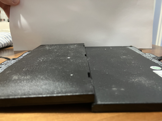 The broken, expanded battery on the left, the normal sized one on the right.  It's amazing the laptop still held together.