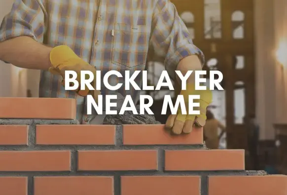 Professional bricklayer laying red bricks on a construction site with precision and tools in hand.