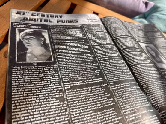 A close-up of a magazine page featuring an interview titled "21st Century Digital Punks." The page includes an image of a person named Nele, along with text in German discussing music and personal experiences in a punk band.