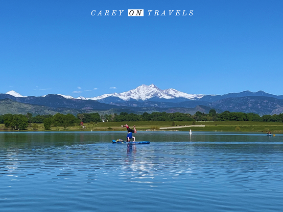 SUP yoga in front of a snowy Long's Peak in Colorado