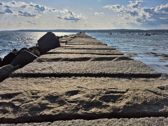 The Dog Bar Breakwater, a granite structure built at the turn of the 19th-20th century to  funnel ships toward the safest pathway to Gloucester.