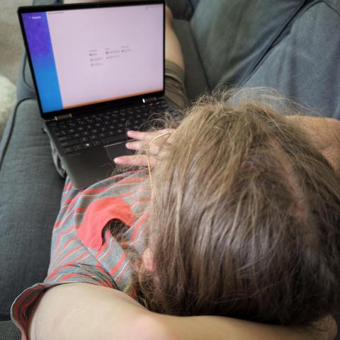 Photo of my son with the linux install screen on his laptop