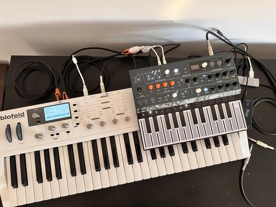 An Arturia Microfreak synthesizer sitting atop a Waldorf Blofeld synthesizer.