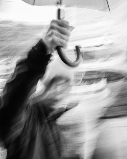 Black and white ICM photo of a person holding umbrella