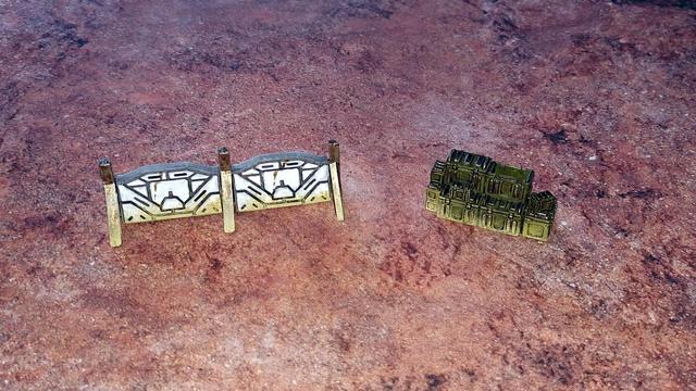 Two small terrain pieces. Pile of crates and a barricade.