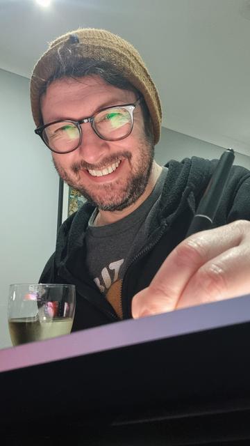Smiling male drawing on display. Hand in foreground