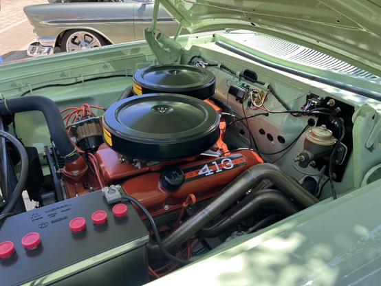 The engine compartment of a classic car with a Superstock 413 engine