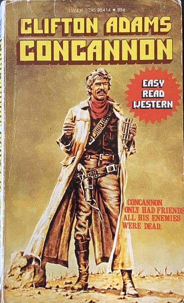 A picture of a paperback called Concannon by Clifton Adams. The cover show a mustached man who vaguely looks like charles bronson or middle aged josh brolin smiling wearing a duster and a pistol on a gunbelt. In one hand he holds a cigar and in the other a bundle of dynamite. A red starburt blued on one side says in all caps “Easy Read Western.”