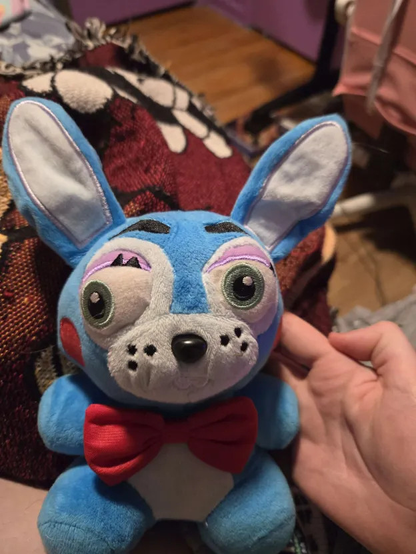 A knockoff plush doll of Spring Bonnie based on the funko design where he has a lazy eye.