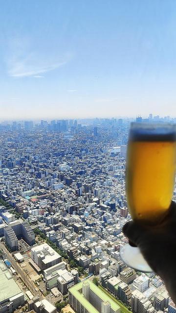 View of Tokyo from Tokyo Skytree, with a beer glass in the foreground.